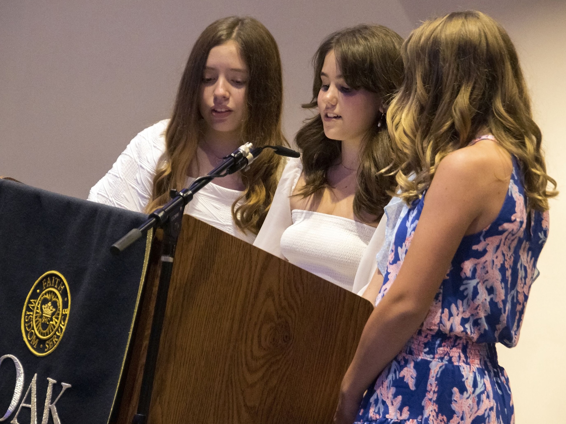 Three students sing responsorial psalm during Mass,