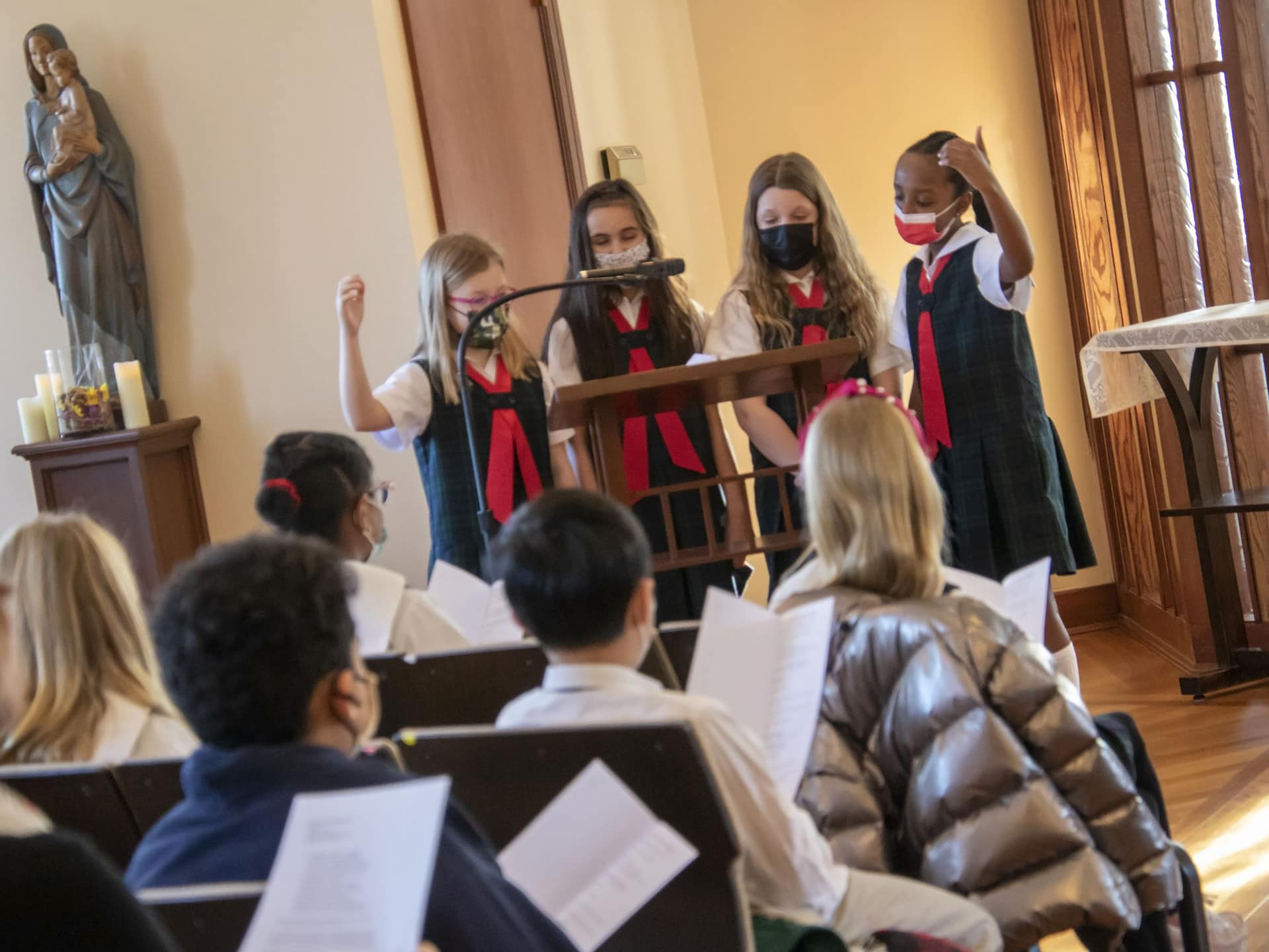 Four students lead responsorial psalm during prayer service.