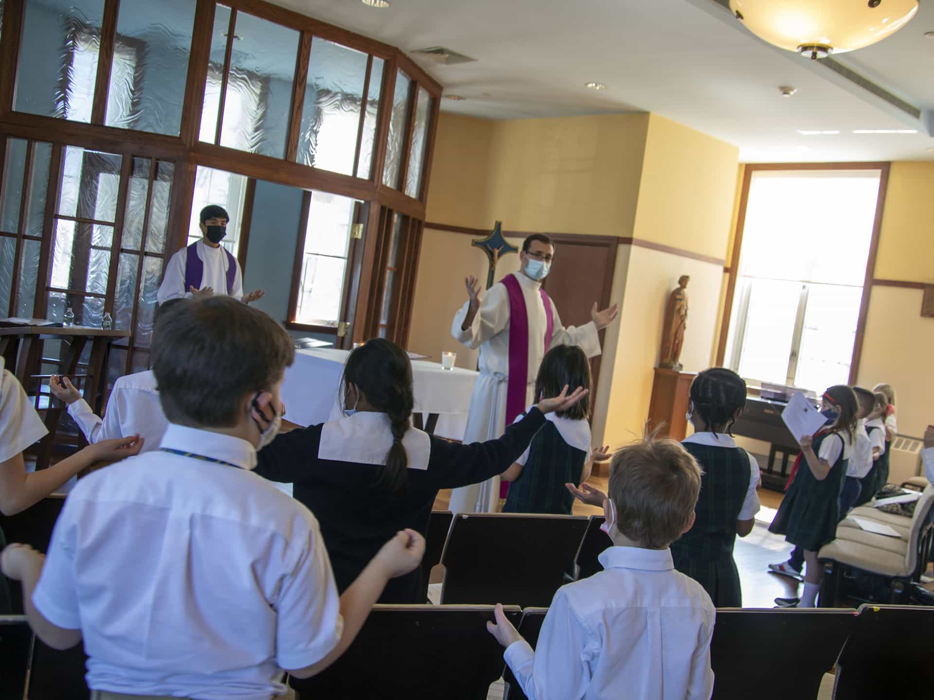 Priest leads Our Father prayer during special Lenten prayer service,