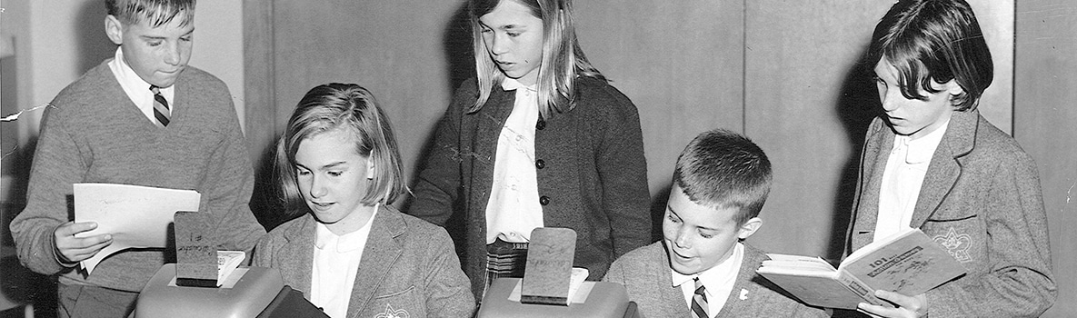 Historical image of students using counting machines from either the 1950s or 1960s.