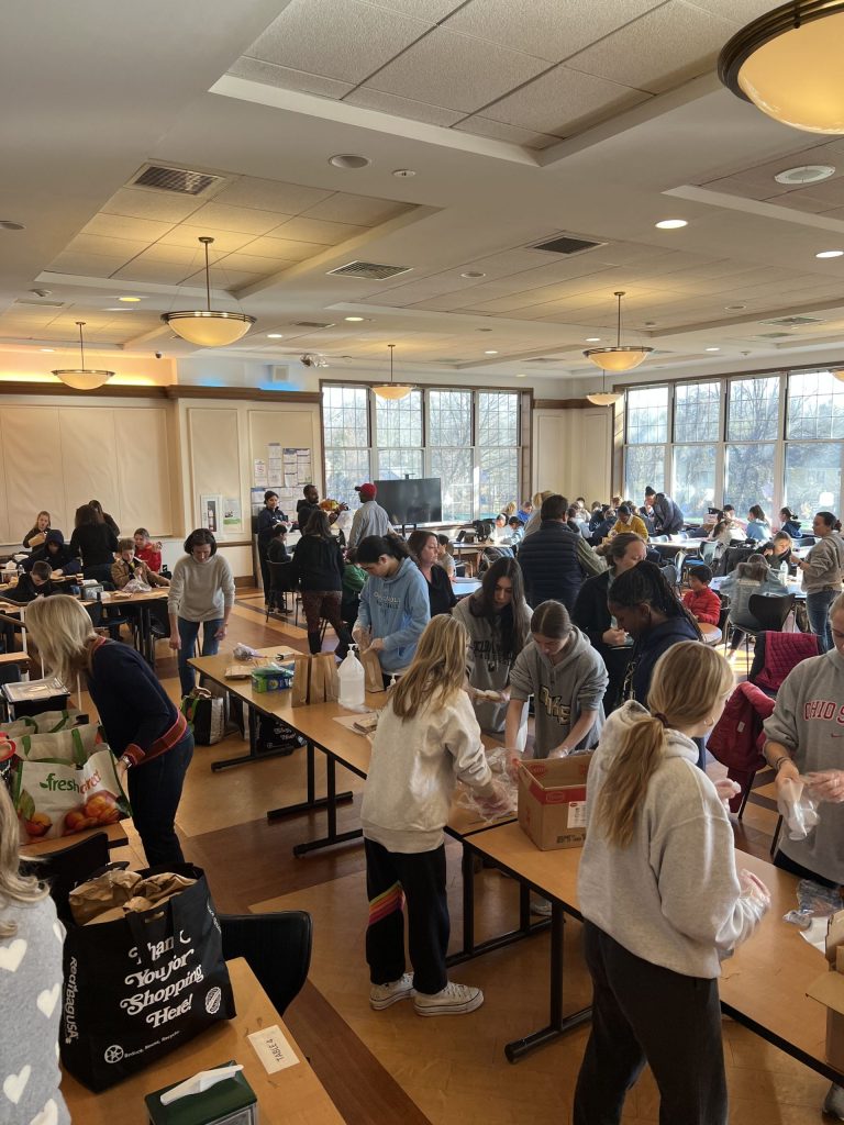 While some may see the third Monday in January – Dr. Martin Luther King Jr. Day – as simply a day off from work or school, an increasing number of socially conscious individuals are celebrating MLK Jr. Day as a day of service. Such was the case with a group of Oak Knoll families who gathered at the school last Monday to assemble lunch bags for Bridges Outreach.