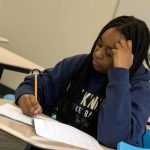 Girl working on kindness journal